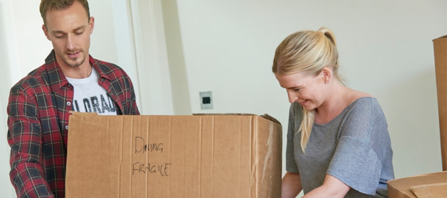 Young couple carrying box