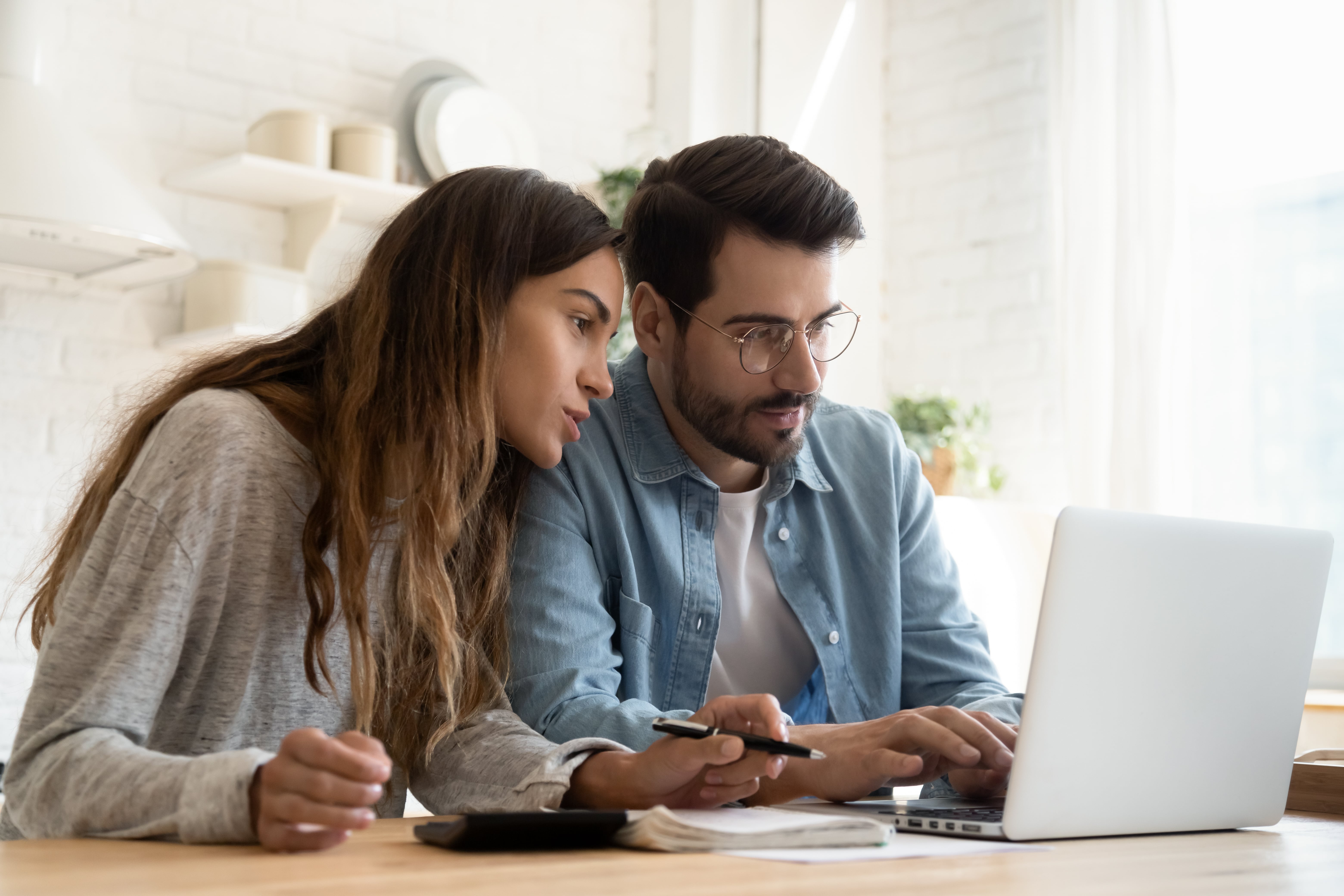 Couple applying for a mortgage on laptop