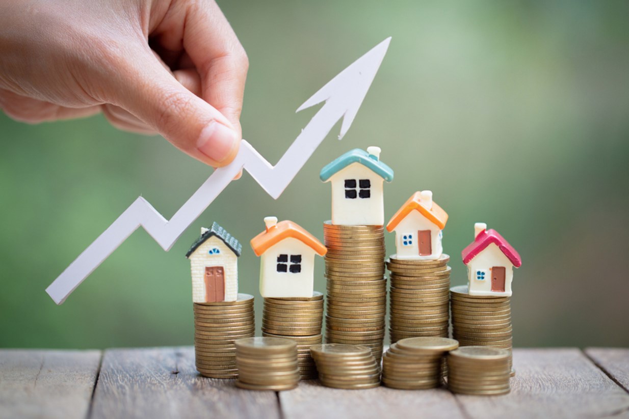 Image of houses on stack of coins